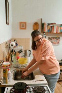 How do I remove hard water stains from my sink?